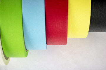Bright colorful tape rolls in a pattern on an isolated white background with room for text and other objects! 