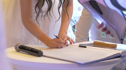White bride signing marriage paper