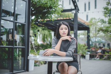 Portrait of young businesswoman use mobile phone while sitting in comfortable coffee shop during work break, charming happy female reading fashion news on cell telephone