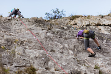 Team climbers ascend to the cliff