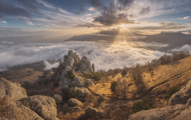 Beautiful sunset above the clouds in the mountains © vitaliiaberestok