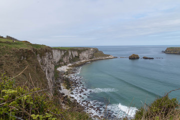 Atlantic Ocean coast with cliffs and rocks, beach with sand, blue water, daylight, springtime
