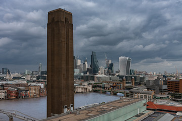 Brick chimney , on background City of London.