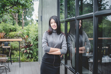 Portrait of designer woman standing in front of small vintage store. Small business