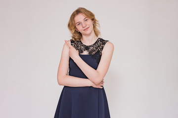 portrait of a beautiful blonde girl on a white background showing a emotions in different poses