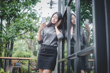 Portrait of young businesswoman use mobile phone while sitting in comfortable coffee shop during work break  charming happy female reading fashion news on cell telephone
