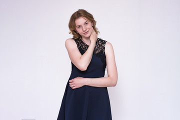Fototapeta premium Portrait of a young happy beautiful blonde girl on white background with a smile.