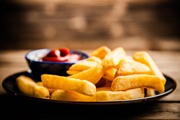 French fries on wooden table