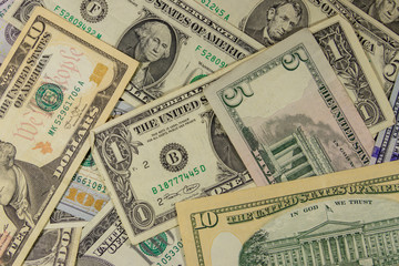 Fototapeta na wymiar Background of different dollar banknotes