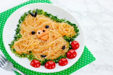 Fun food idea for kids - cute yellow chicken rice noodles funchoza with green onion and cherry tomatoes for healthy lunch