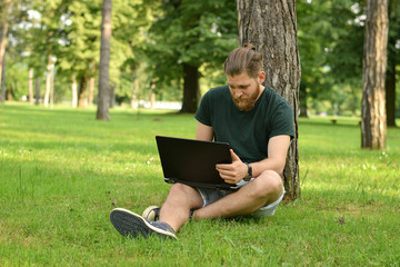 man using lap top outdoor
