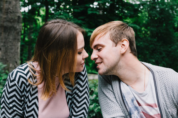 Obraz premium Two lovers walk around the park, kiss and hug, a love story.
