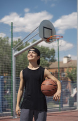 Naklejka premium Young Man Holding a Basketball Ball