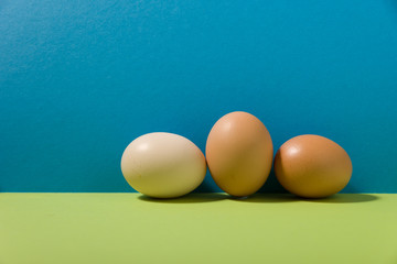 three eggs on green and blue background