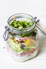 Salads with arugula  radish  tomatoes  seeds and cucumber in glass jars. Healthy food  diet and detox concept