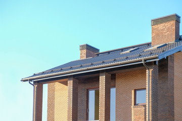 Brown house facade over blue sky