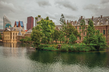 Hofvijver lake with the Binnenhof (Gothic government buildings) and skyscrapers in The Hague. Important political center, is a mix of historic city with modernity. Western Netherlands.
