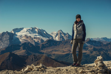 Fototapeta premium pretty young woman watching the beauty of nature in south tyrol, passo falzarego, italien dolomites