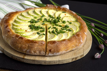 Homemade rustic pie with zucchini and green onions.