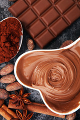 Chocolate bars on table with chocolate powder.