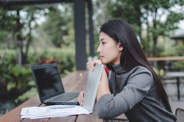 Business woman working in coffee shop with documents