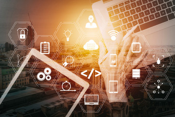 cyber security internet and networking concept.Businessman hand working with laptop computer and digital tablet with buildings exposure