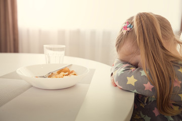 Girl refuses to eat. Child meal difficultes theme. - obrazy, fototapety, plakaty