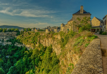Bozouls, Midi Pyrenees, France - September 21, 2017: View of the houses at the edge of the canyon...