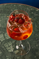 Tomato sprits cocktail on bar counter table. Refreshing Twist classic cocktail with Tomatoes, Aperol, Proseco and soda top, close-up