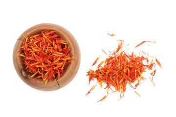 Heap of saffron in wooden bowl isolated on white background. Top view. Flat lay