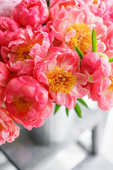 Lovely flowers in glass vase. Beautiful bouquet of peonies sort of coral charm. Floral composition, scene, daylight. Wallpaper. Vertical photo