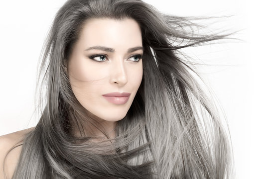 Young woman with long trendy silver hair. Care and hair products concept