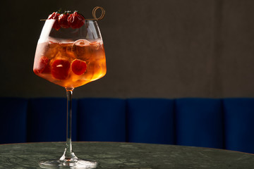 Tomato sprits cocktail on bar counter table. Refreshing Twist classic cocktail with Tomatoes, Aperol, Proseco and soda top, close-up