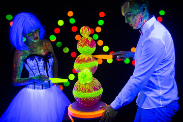 Neon photography bright colorful on a dark background in ultraviolet rays, couple in love guy and...