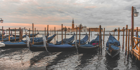 ondolas moored by Saint Mark square with San Giorgio di Maggiore church in Venice