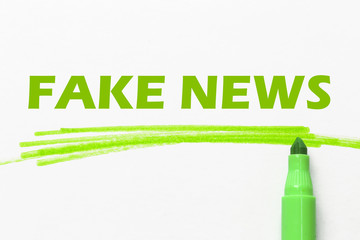 fake news word written with green marker