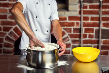 chef making dough for pizza. Man hands preparing bread. Concept of baking and patisserie