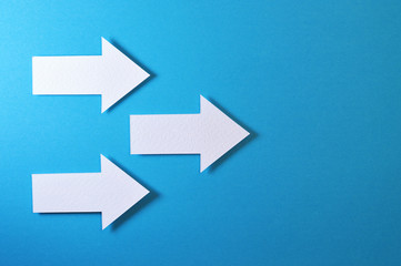 three solid arrows on blue background