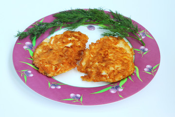 The fried chop from chicken in egg on a plate with greens.