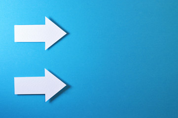 two solid arrows on blue background