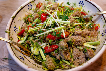 A Bowl of freshly prepared Italian Bread Salad on a wooden Table