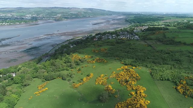 Aerial footage of the village of Langbank on the south shore of the Firth of Clyde over to Dumbarton on the far shore. 