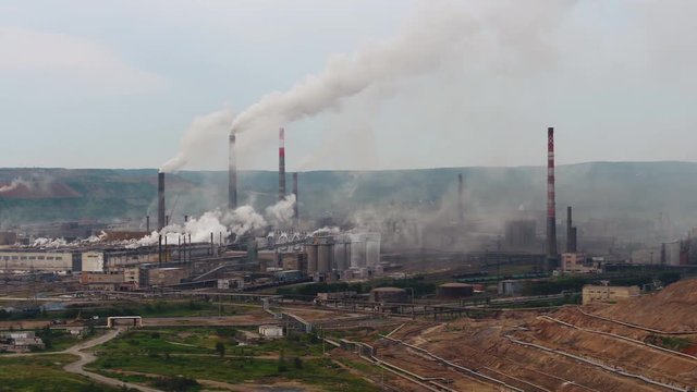 Large industrial concrete cement building plantin Russia Spassk-Dalny Vladivostok, Russia Primorsky krai regional center. Smoke tube pollution. Aerial drone from above 4k footage. Summer sunny day 4k