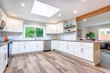 Open concept kitchen equipped with skylight.