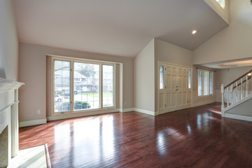 Empty family room with vaulted ceiling.