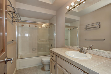 Bathroom with vanity cabinet and shower.