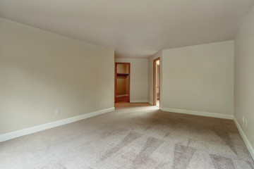 Empty bedroom with carpet floor.