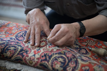 Fototapeta premium Man repairing a carpet