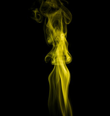 Obraz premium Yellow smoke on black background