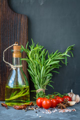 Naklejka na ściany i meble Rosemary oil. Selection of spices herbs. Ingredients for cooking. Food background on stone table.